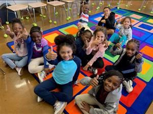 smiling students with thumbs up 