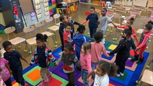 students dancing in two circles 